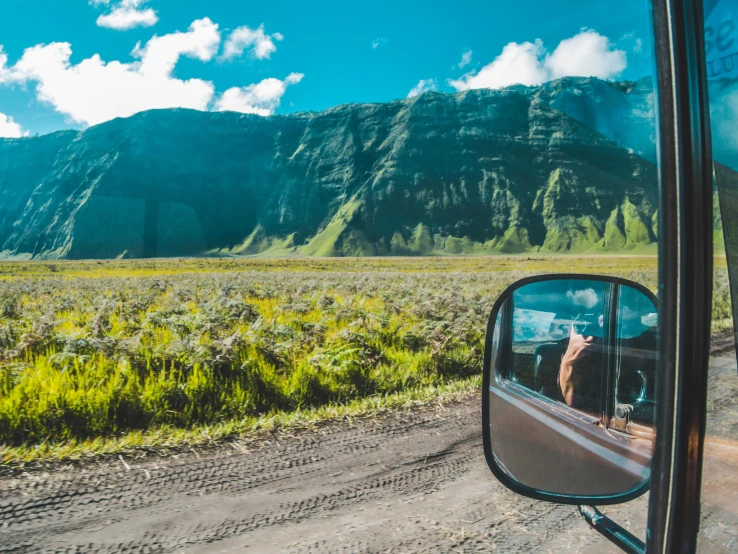 a truck is parked next to a road near a mountain