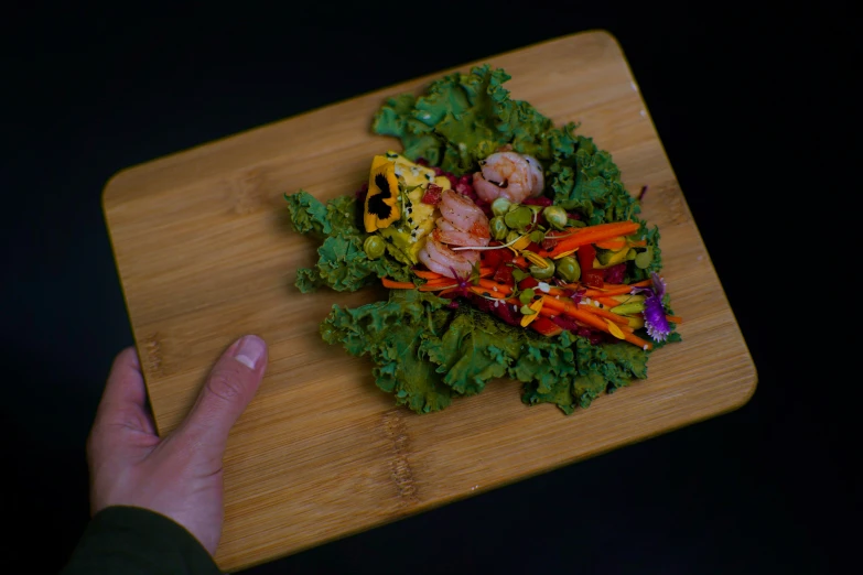 a bowl of mixed vegetables with shrimp and other toppings