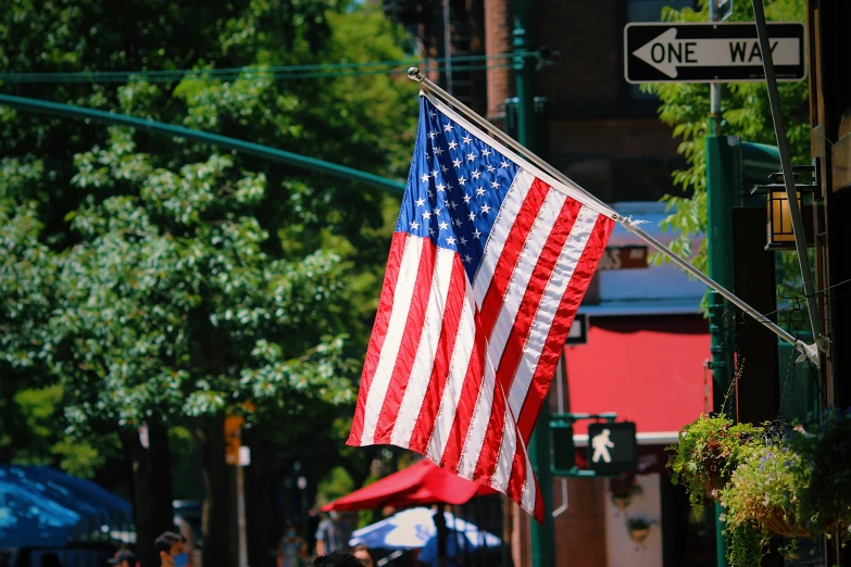 there is an american flag hanging from the pole