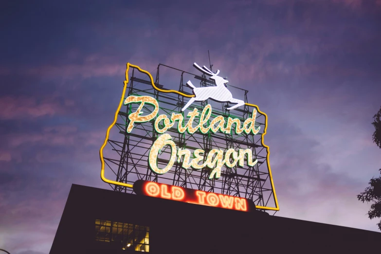 the neon sign for a town named portland oregon on a building