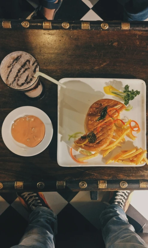 a plate with some shrimp and fries is on a table