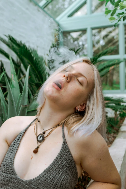 a woman with long blond hair is smoking