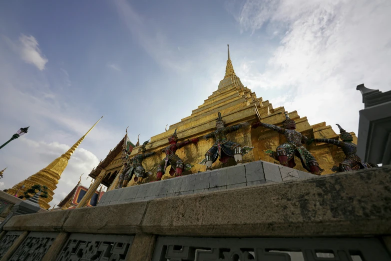 the gold statue at the entrance to the temple has various decorations