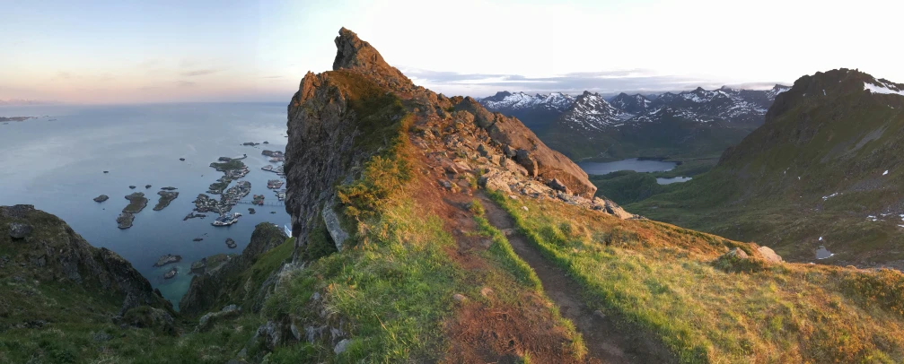 a rock mountain with an alpine view as the sun sets