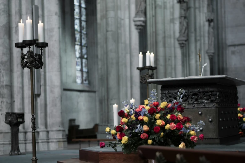 a church with a bunch of flowers on the alter