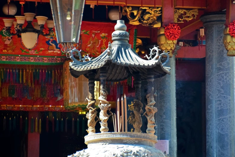 a large lantern above an ornate white bench