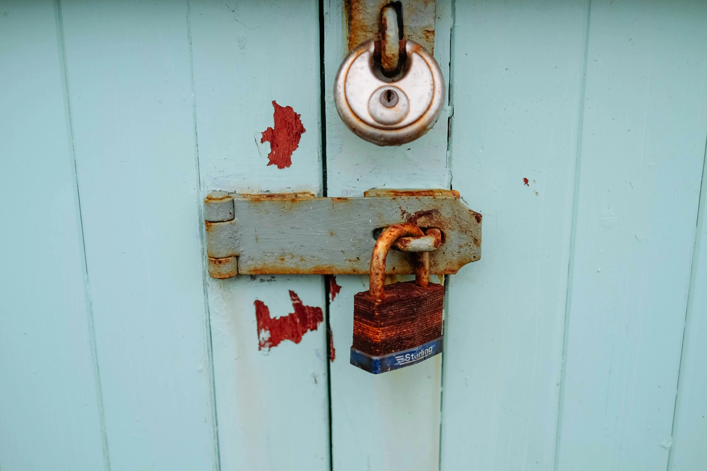 a closed lock that is attached to a wooden door