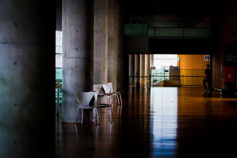 the floor is covered in wood, and two chairs are visible