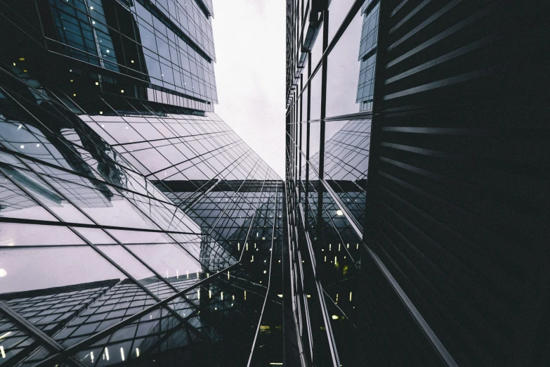 a tall building with lots of windows next to a tall white building