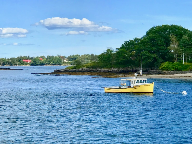 a yellow boat out on the water in the ocean