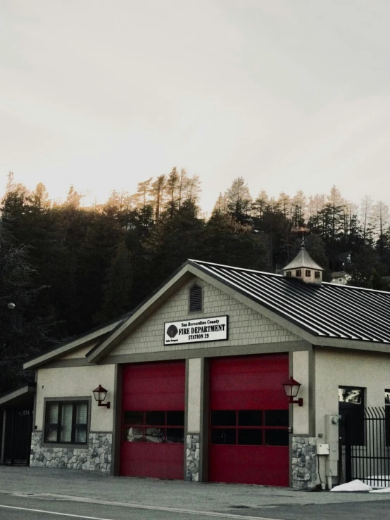 two large garages sit beside each other in front of a mountain