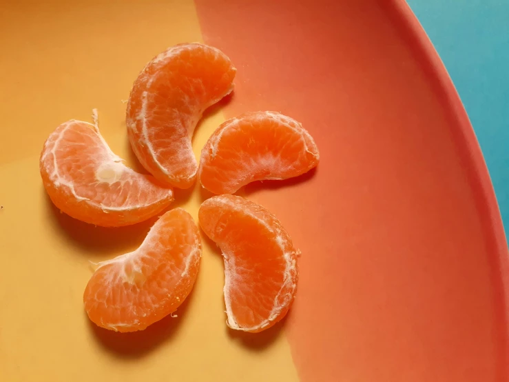 an orange cut in half and placed on a plate