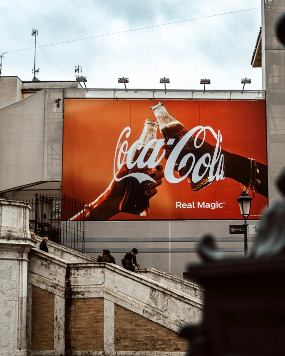 advertising on an outdoor theater building featuring a poster and some steps