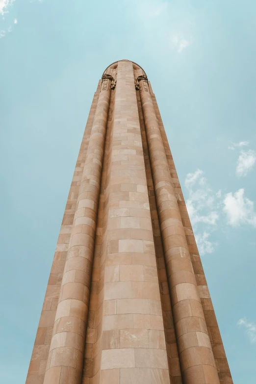 a tall stone tower with two clocks on each of it's sides