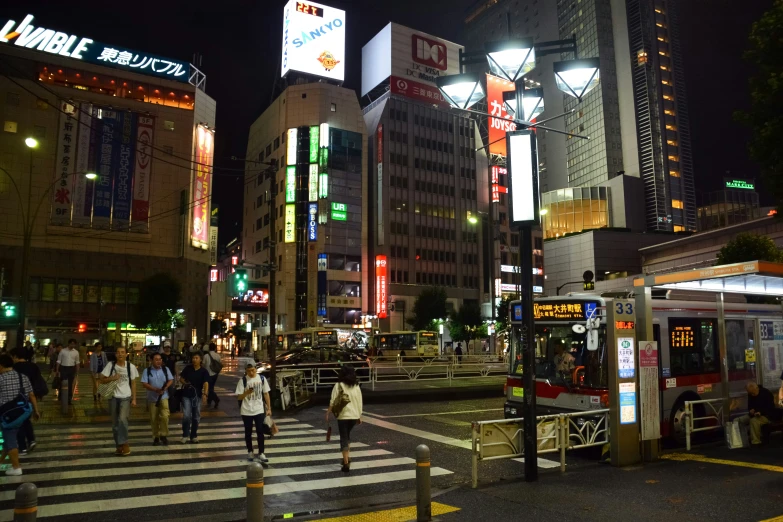 the crowded street of a big city at night time