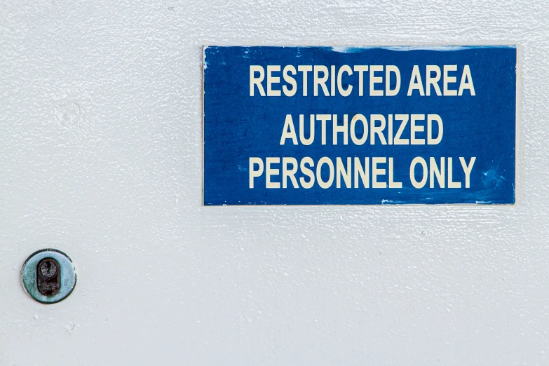 a blue sign that reads restricted area authorized personnel only