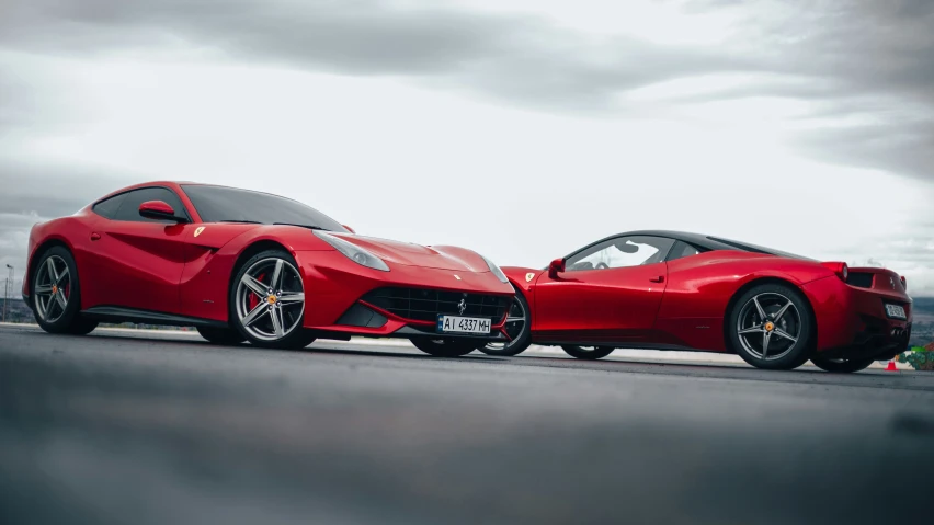 a red sports car on a track with a person sitting in the back