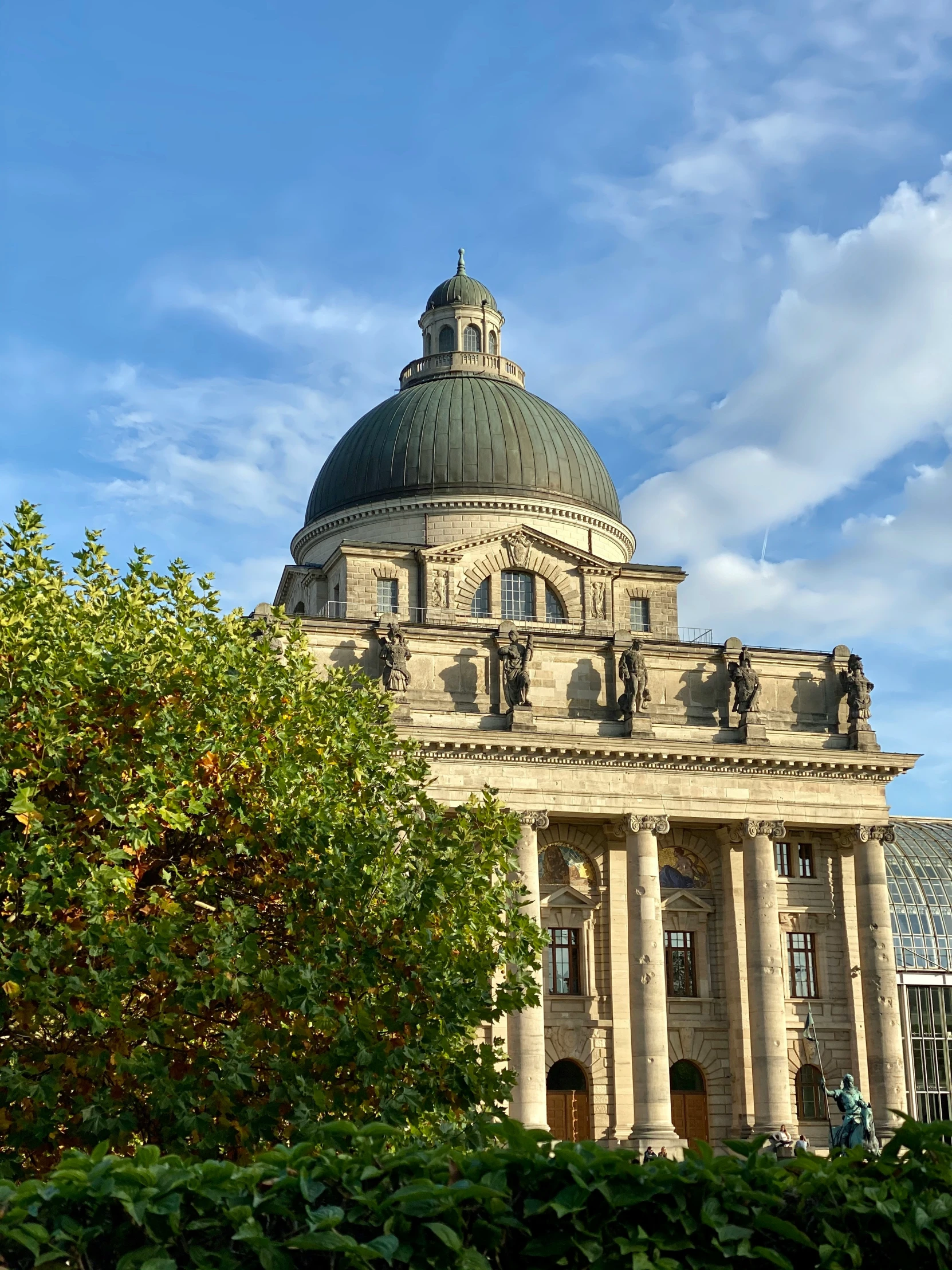 a building with a dome next to a tree