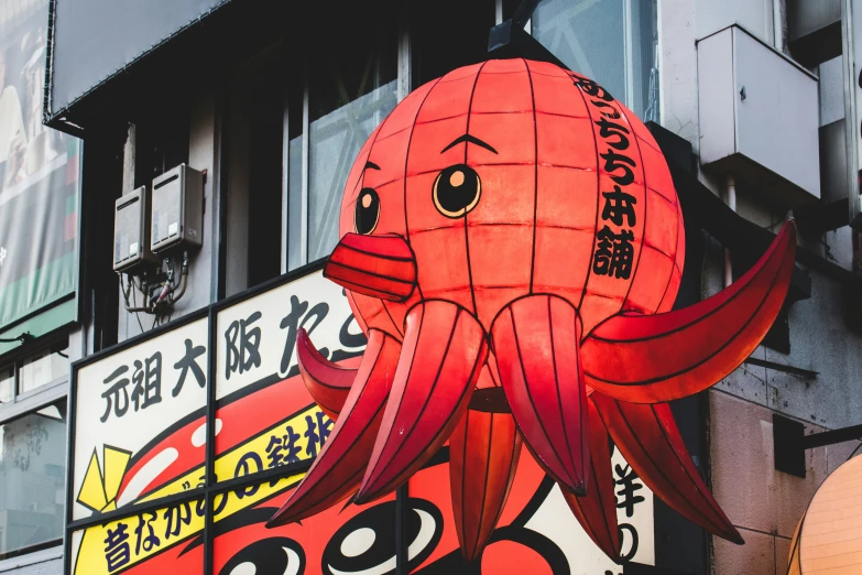 an octo kite in the city outside an asian restaurant