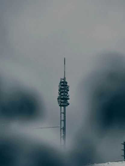 a tower in the middle of a foggy day