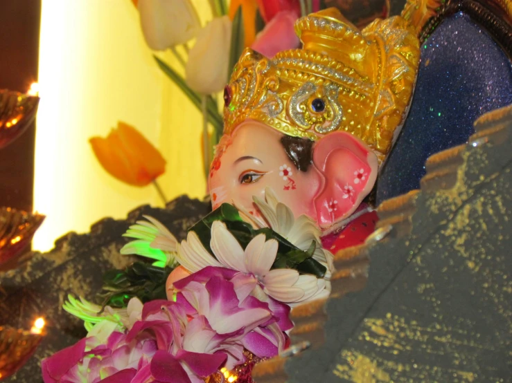 an elaborately decorated gan idol on display at a hindu temple