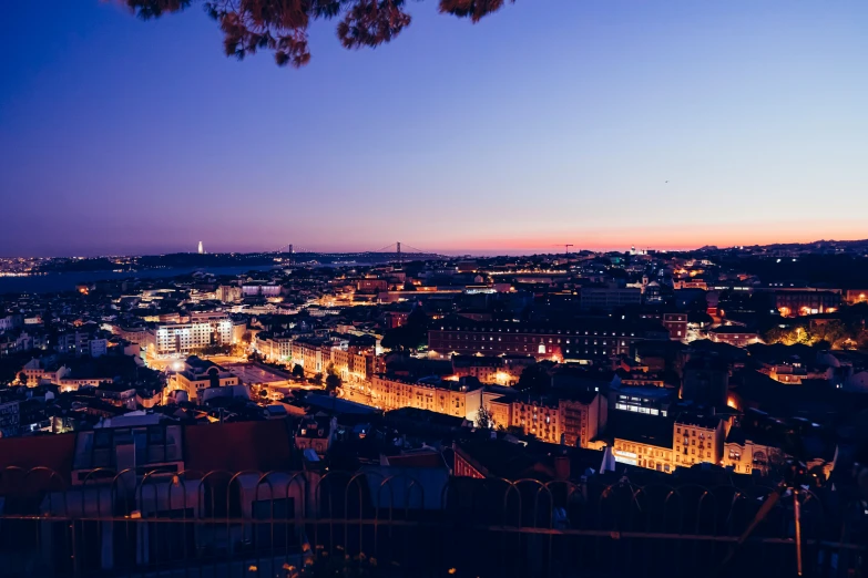 an evening view of a cityscape lit up with lights