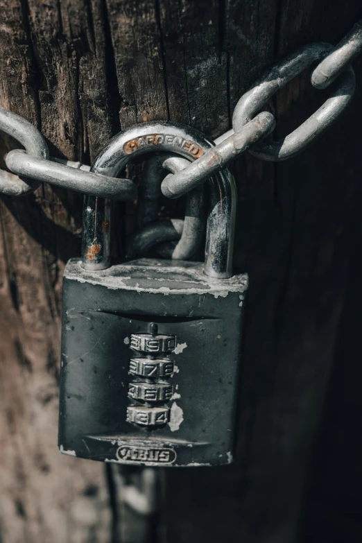 a locked padlock hanging on a wooden door