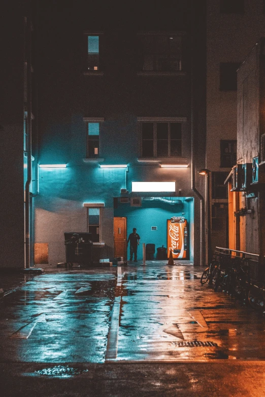 an empty street with a man entering at night