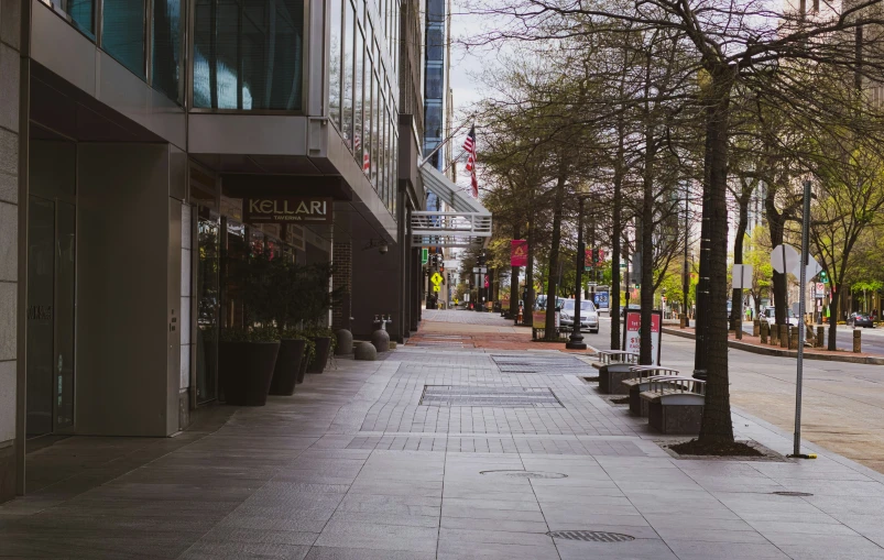 there are empty benches lined on the side walk