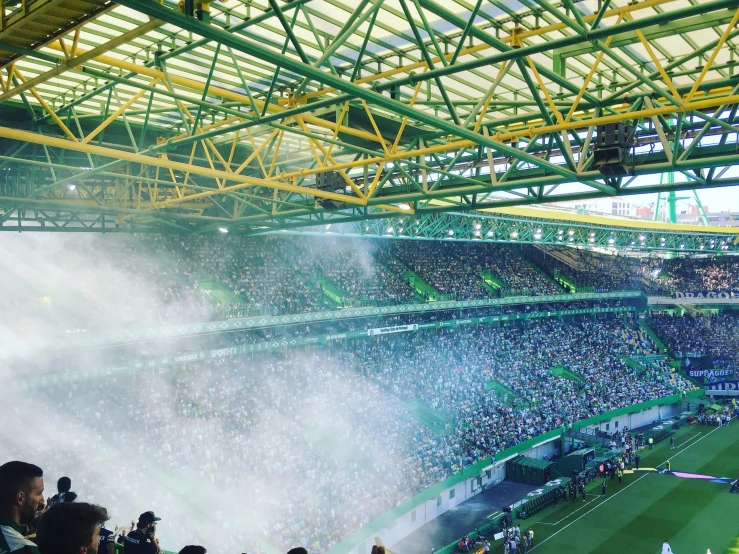 a large crowd watching soccer on a cloudy day