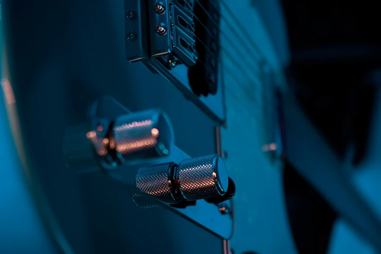 the front view of an electric guitar in blue light