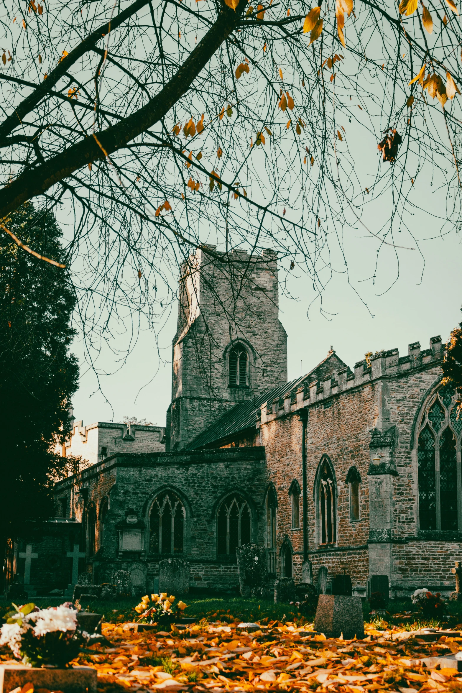 an old church is surrounded by autumn foliage