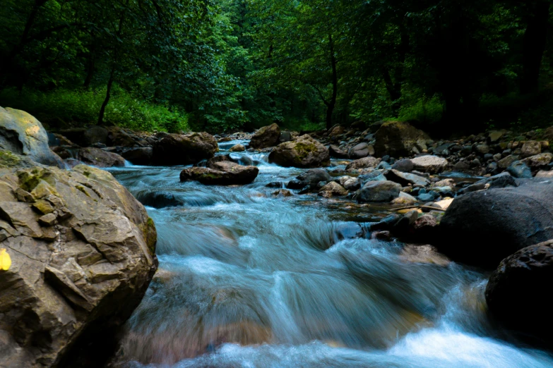 the water is rushing past the rocks by itself