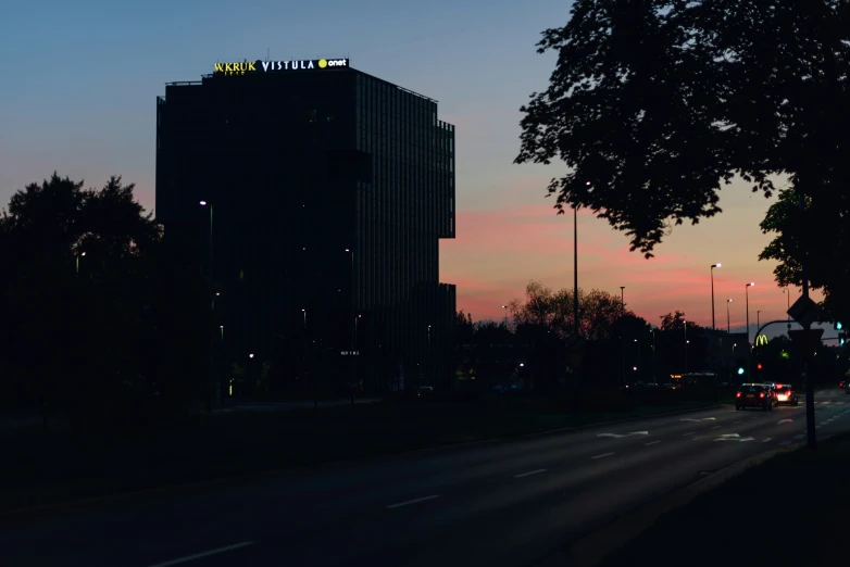 a city street at dusk with the sky in the background