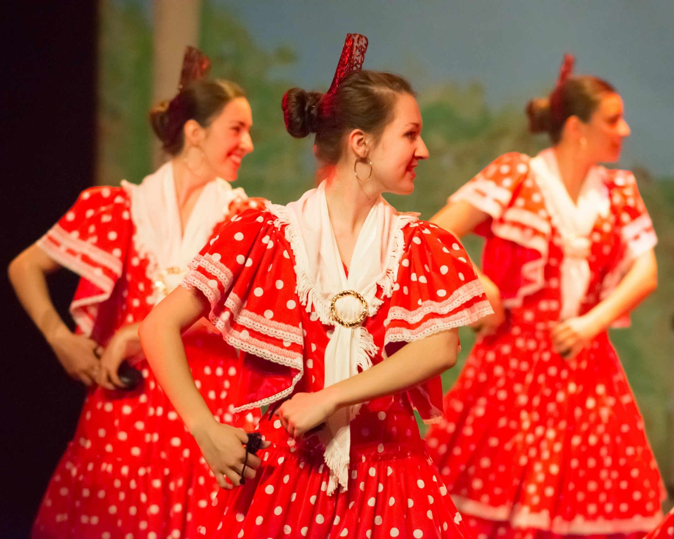 a number of dancers dressed in dresses