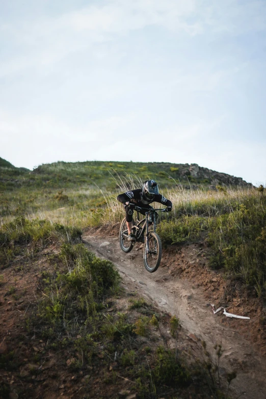 a man riding a mountain bike on top of a dirt trail