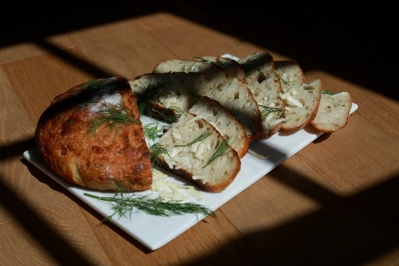 bread on a plate sitting on top of a wooden table