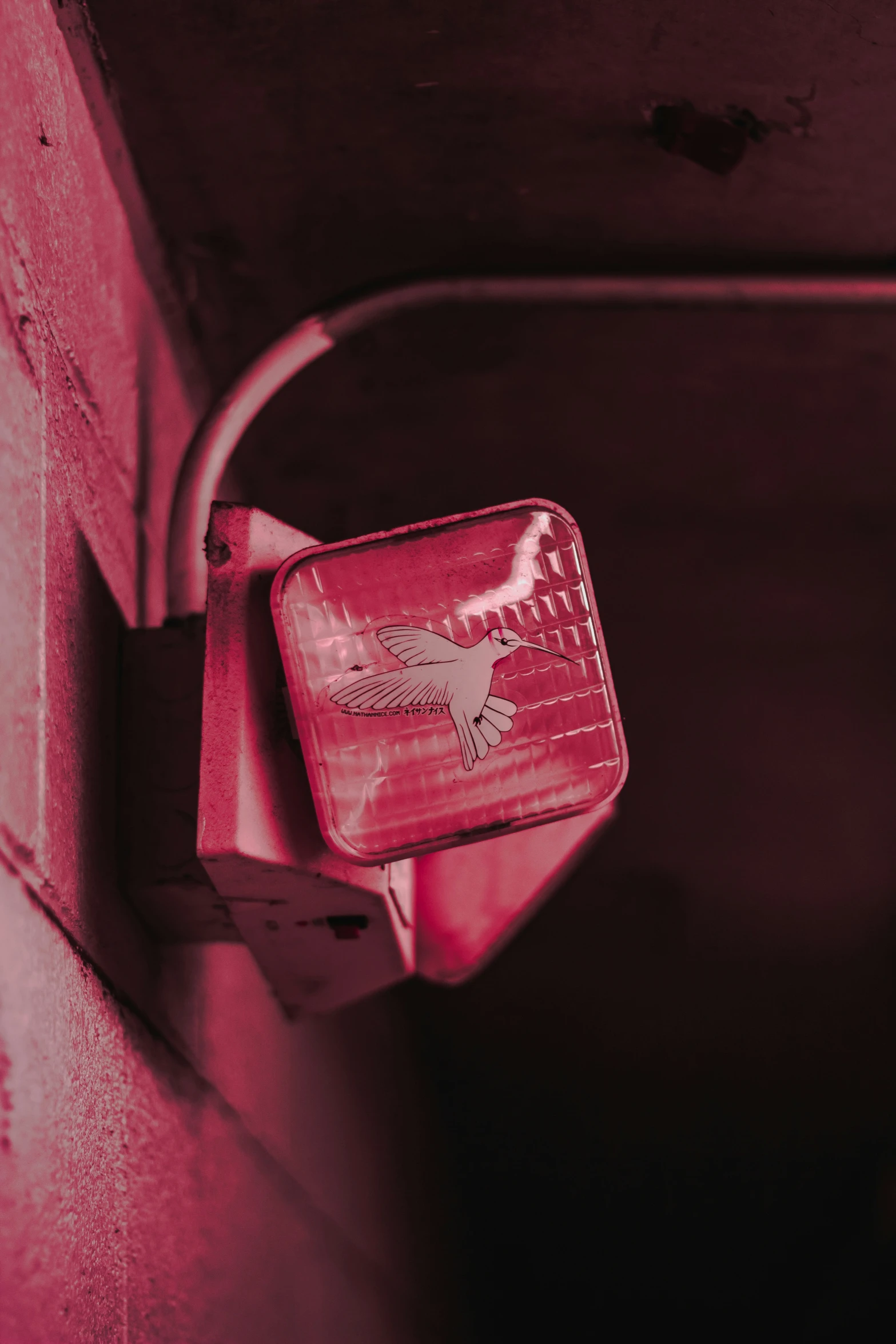 a red parking light attached to a red wall