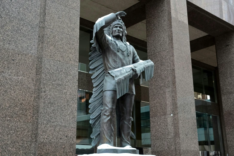 a statue is shown in front of a large building