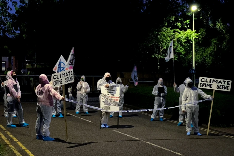 people dressed in white walking down the street