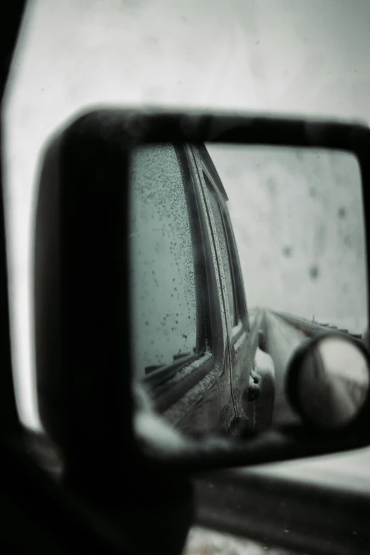 the view of a car is shown in the rearview mirror