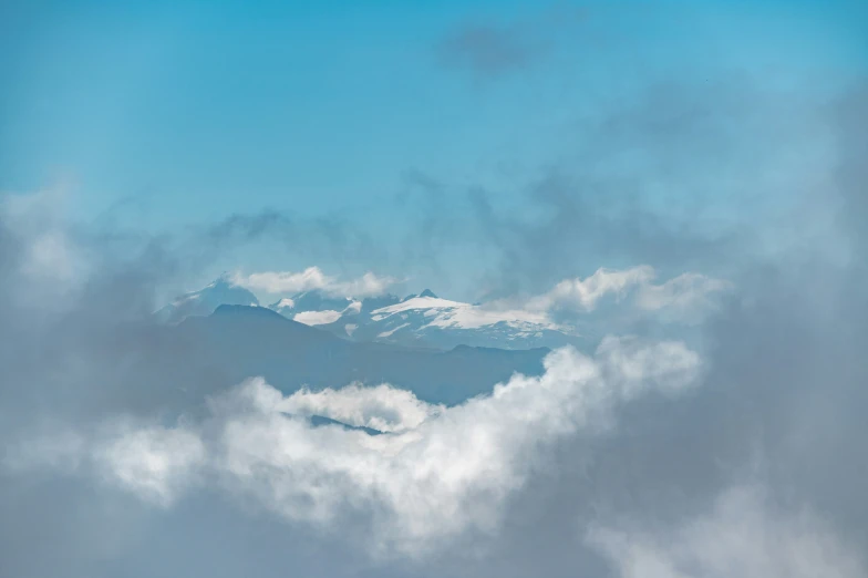 a blue sky with clouds, and mountains in the background