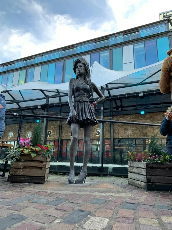 two statues sit in front of an exterior building