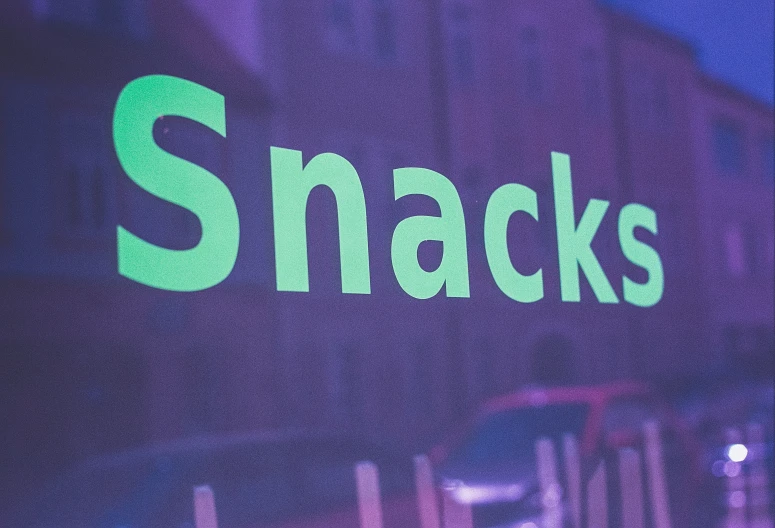 a black and green sign that says snack shoppes