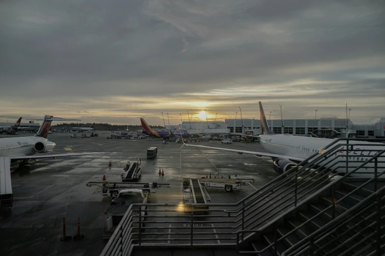 an airport runway with planes and a sky background