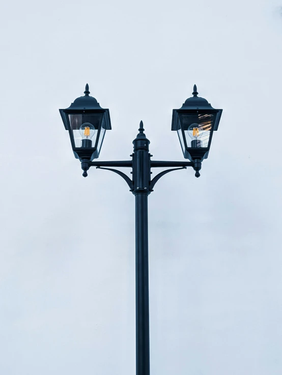 an old fashioned street lamp post on a clear day