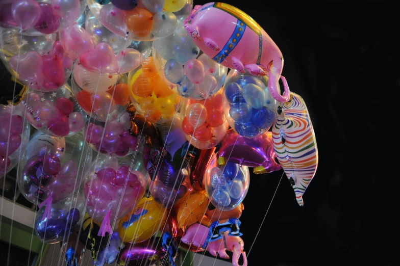 a street scene with a bunch of balloons on the pole