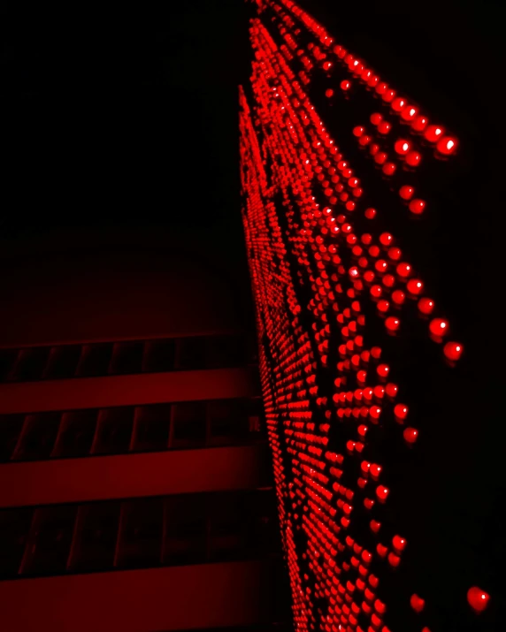 the lights are reflecting off the side of a building