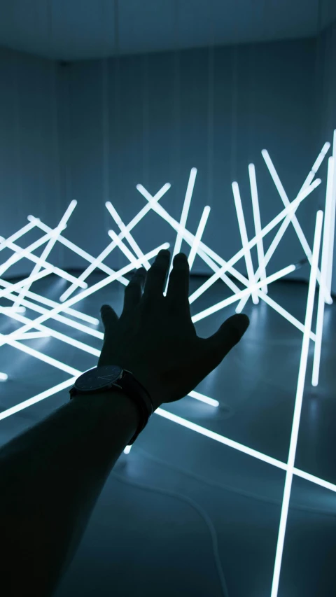 hand reaching towards an array of light colored bars