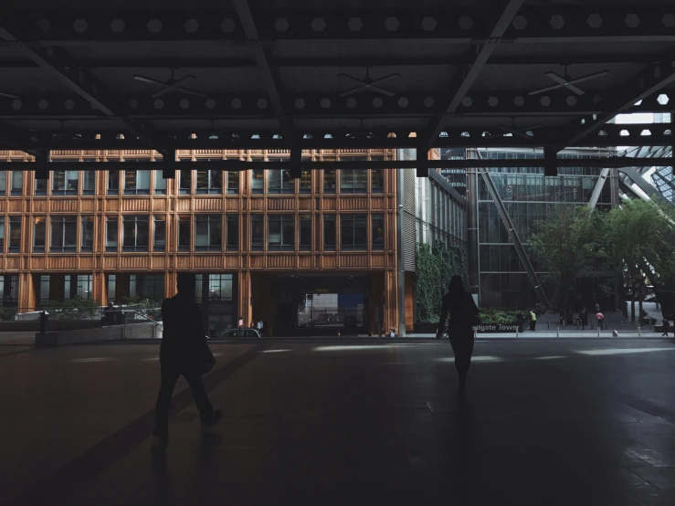 people walking near a large building with some lights on top